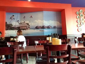 Dining Room with Beach Mural and Wooden Chairs